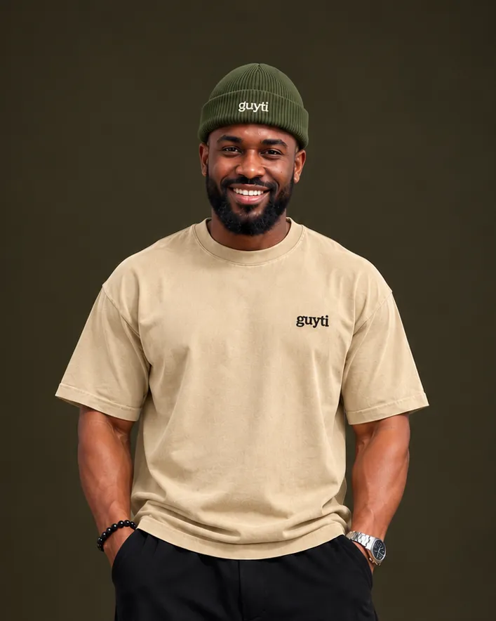 The guyti model in the olive Signature Rib Beanie and a sand Signature Tee